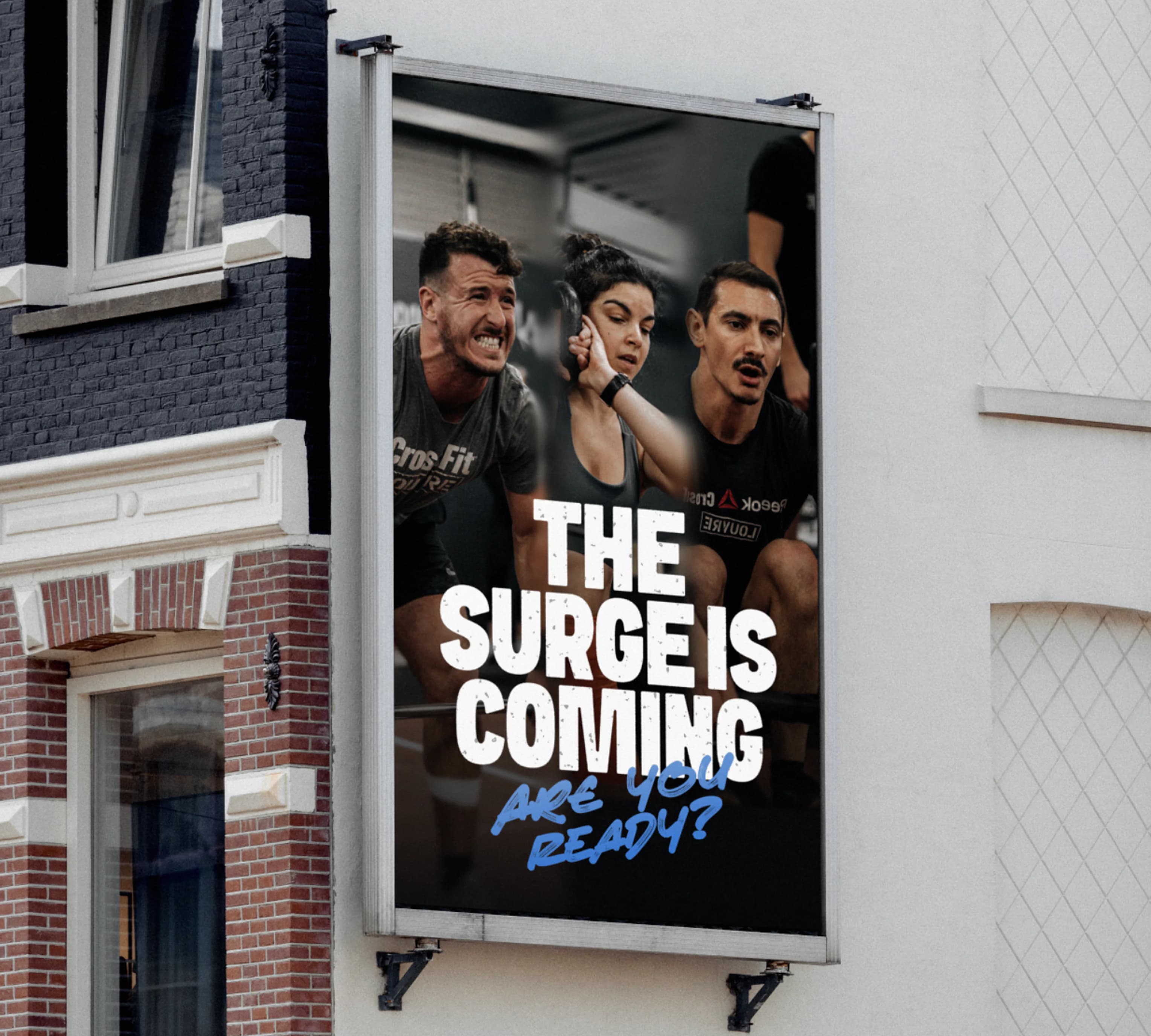 The Surge Is Coming billboard with CrossFit athletes