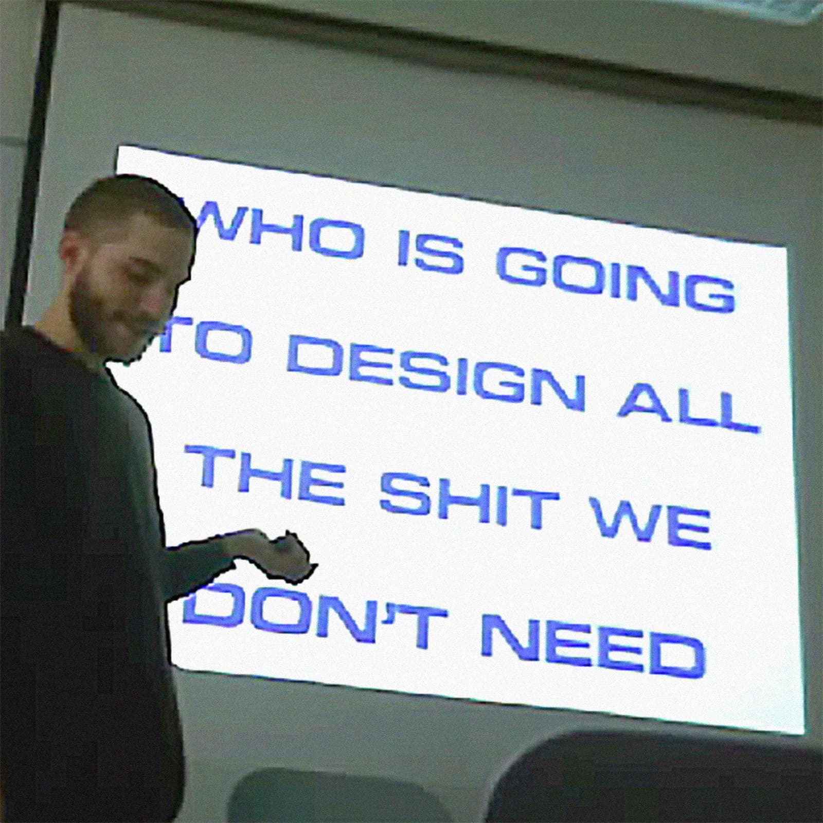 Presenter beside a projection about designing things people do not need